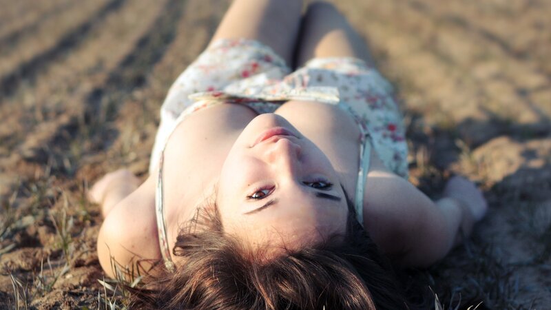 woman lying on ground in sunlight