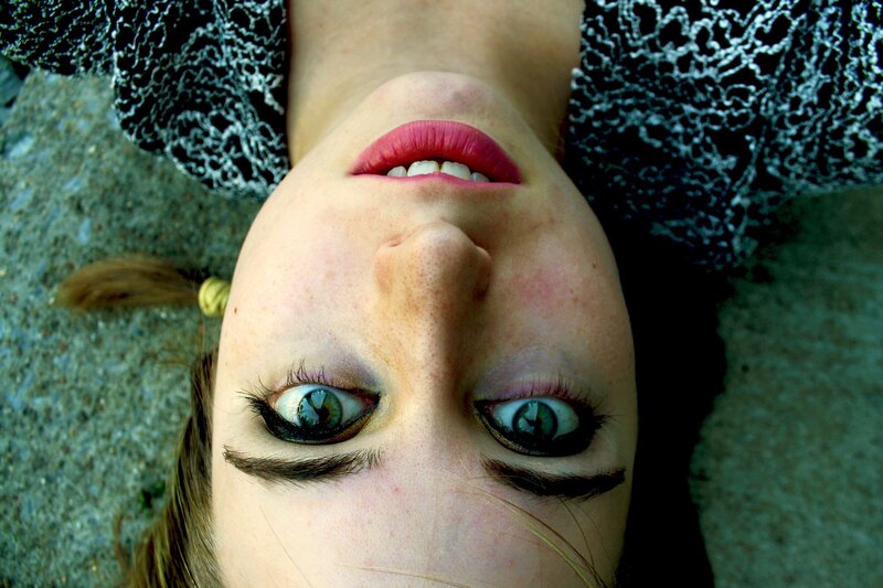 woman lying on ground looking up
