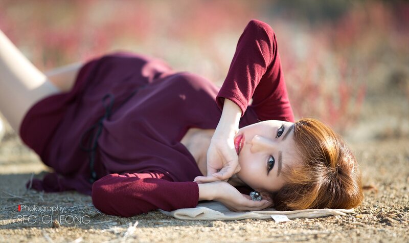 Woman Lying on Ground — Maroon