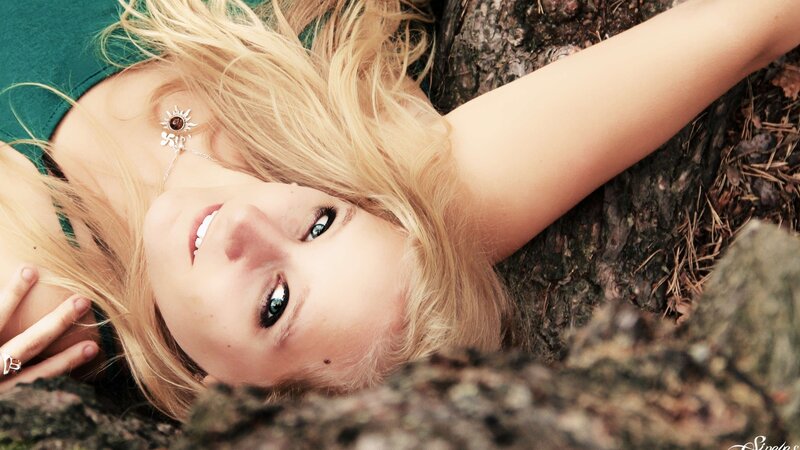 woman lying on ground smiling