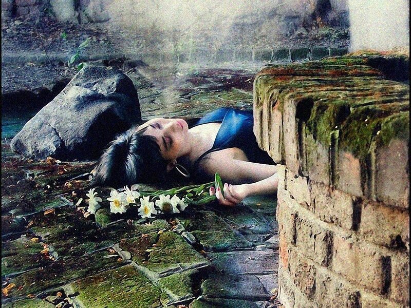 Woman lying on ground with flowers