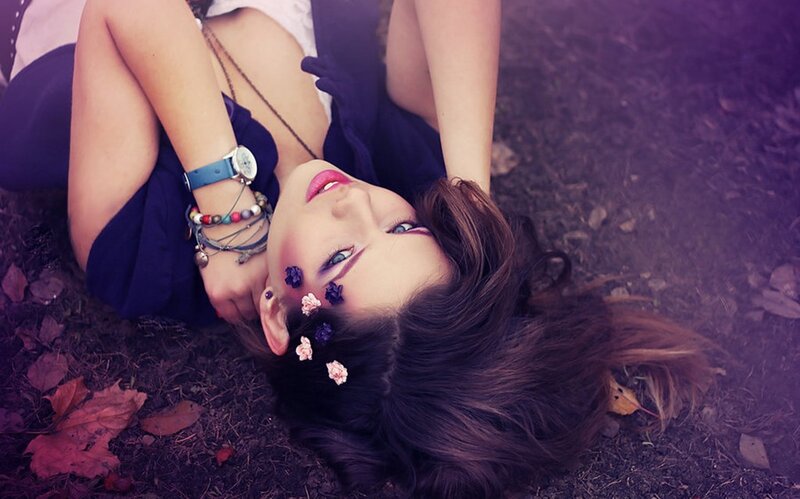 woman lying on ground with flowers