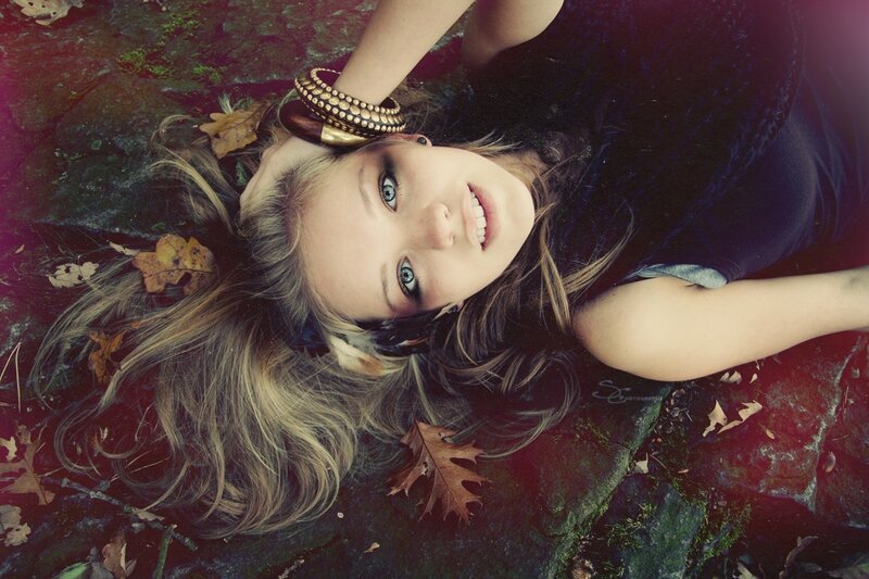 woman lying on ground with leaves