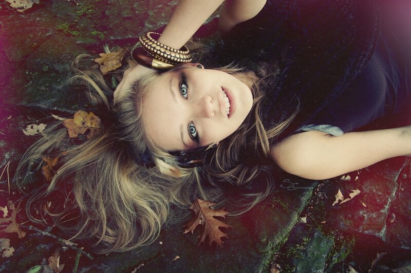 woman lying on ground with leaves