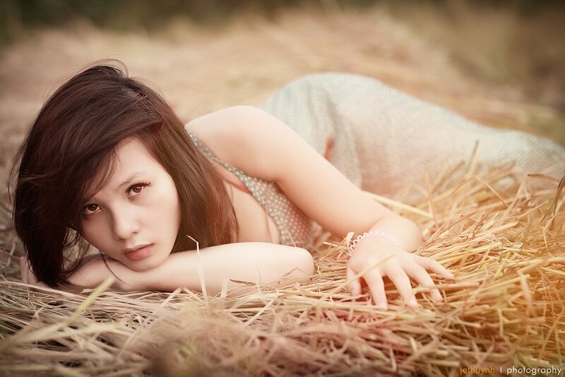 woman lying on hay field