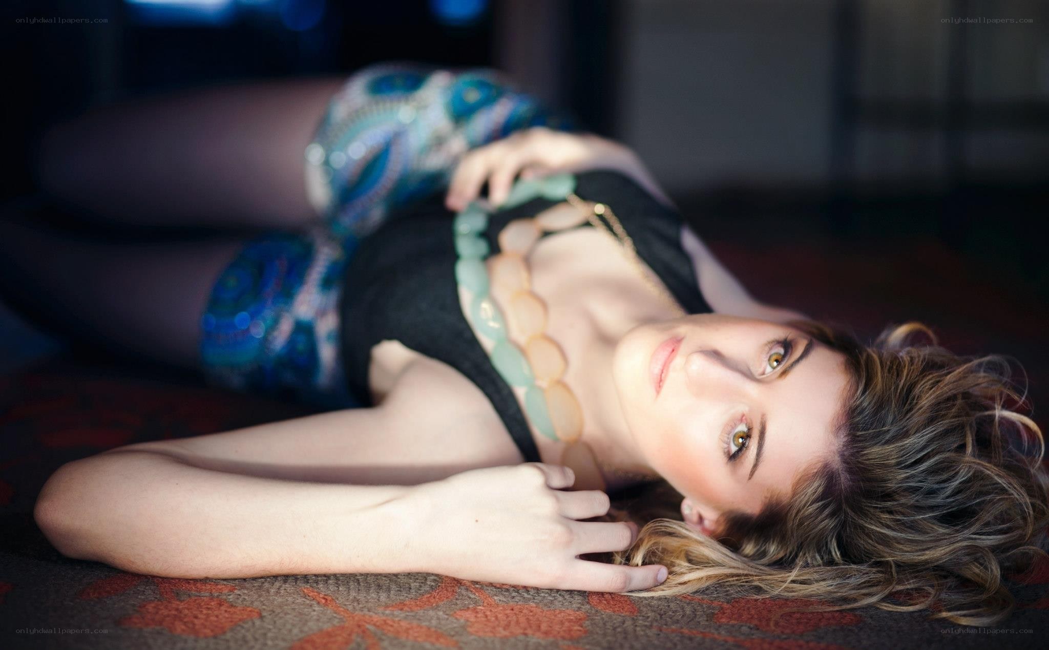 woman lying on patterned rug