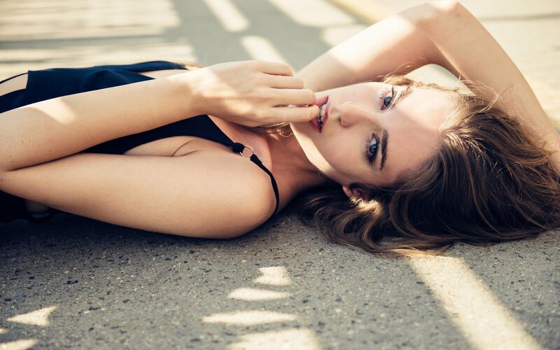Woman Lying on Pavement — Brown, Dramatic