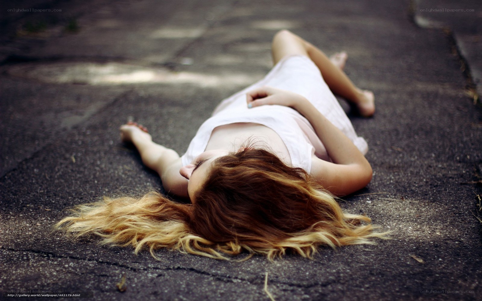 woman lying on pavement