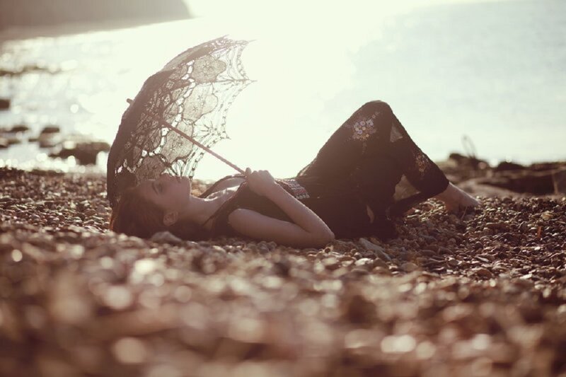 Woman Lying on Pebble Beach