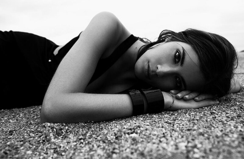 Woman Lying on Pebbles — Black