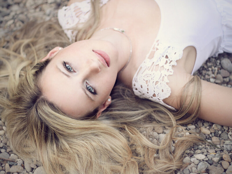 Woman Lying on Pebbles — White