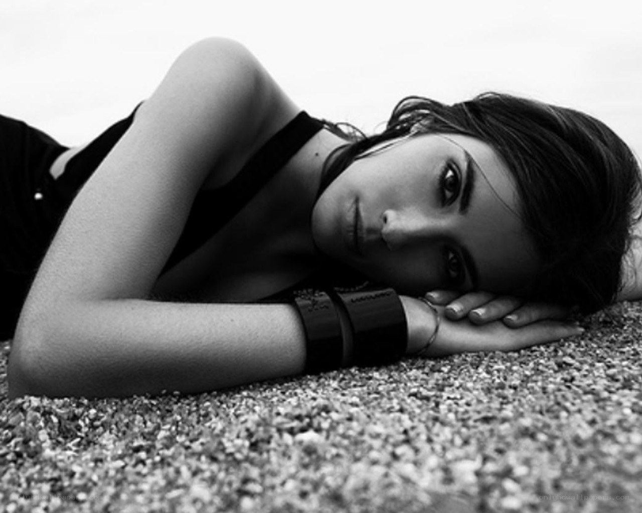 woman lying on pebbles