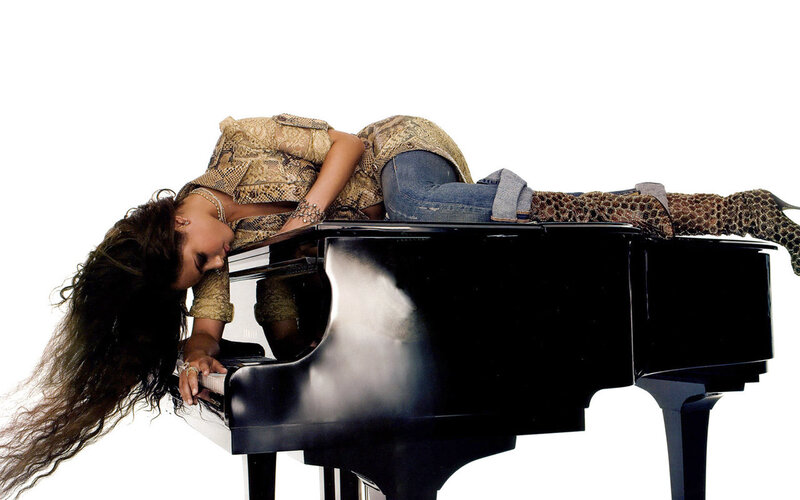 woman lying on piano