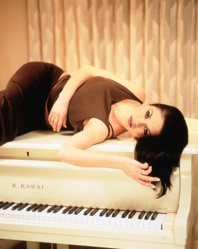 woman lying on piano