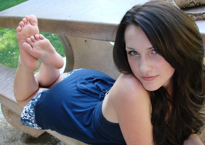 woman lying on picnic bench