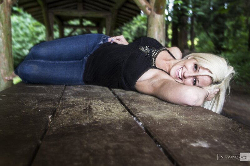 woman lying on picnic table