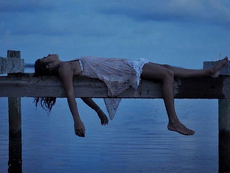 Woman Lying on Pier