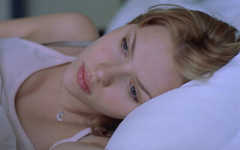 woman lying on pillow