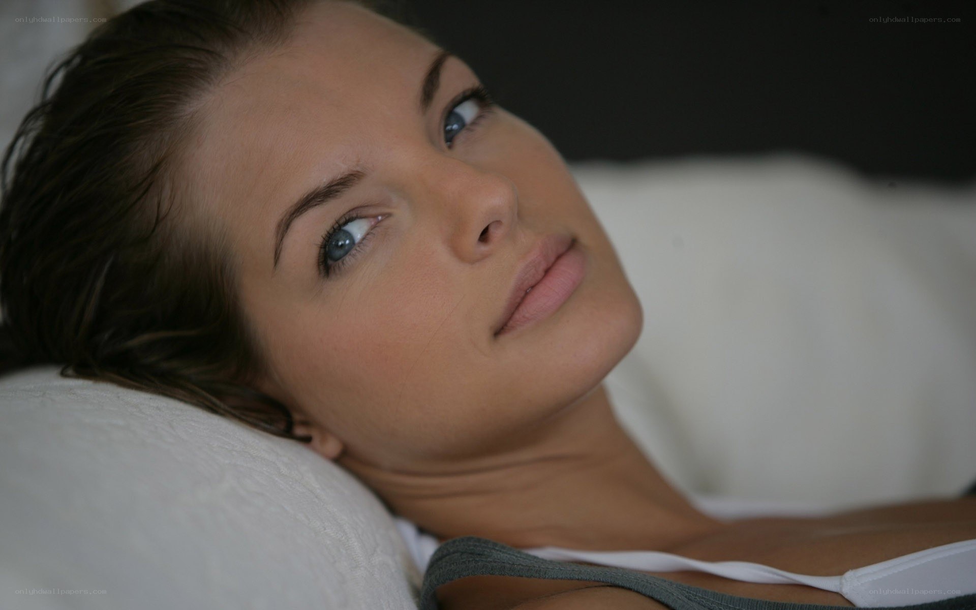 woman lying on pillow
