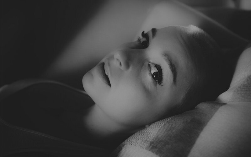 woman lying on pillow