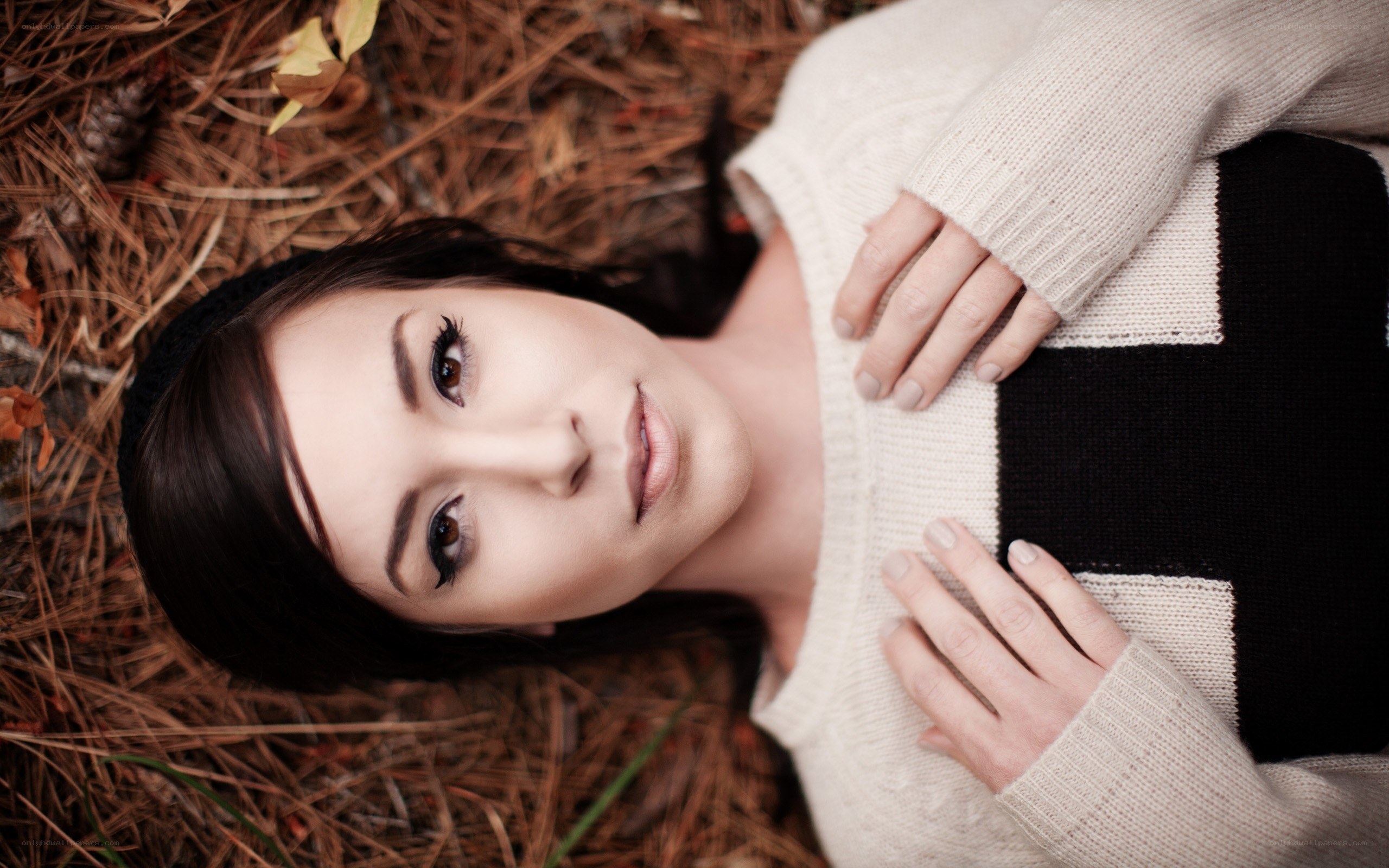 woman lying on pine needles