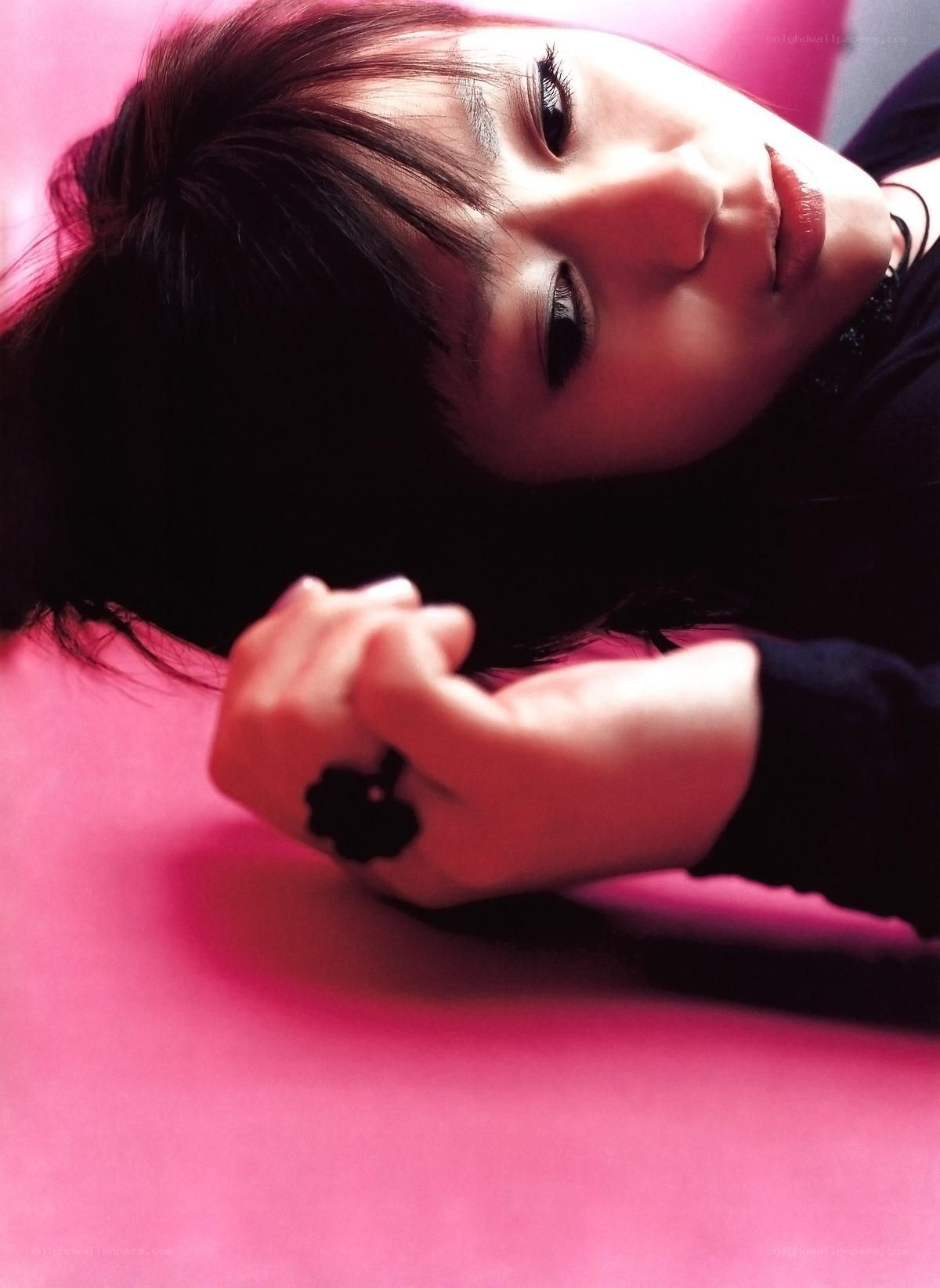 woman lying on pink surface