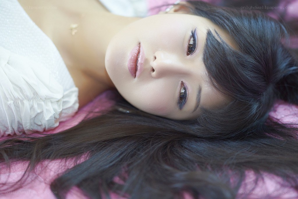 woman lying on pink surface