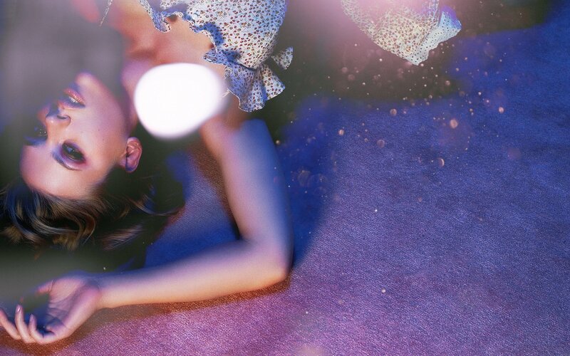 woman lying on purple carpet