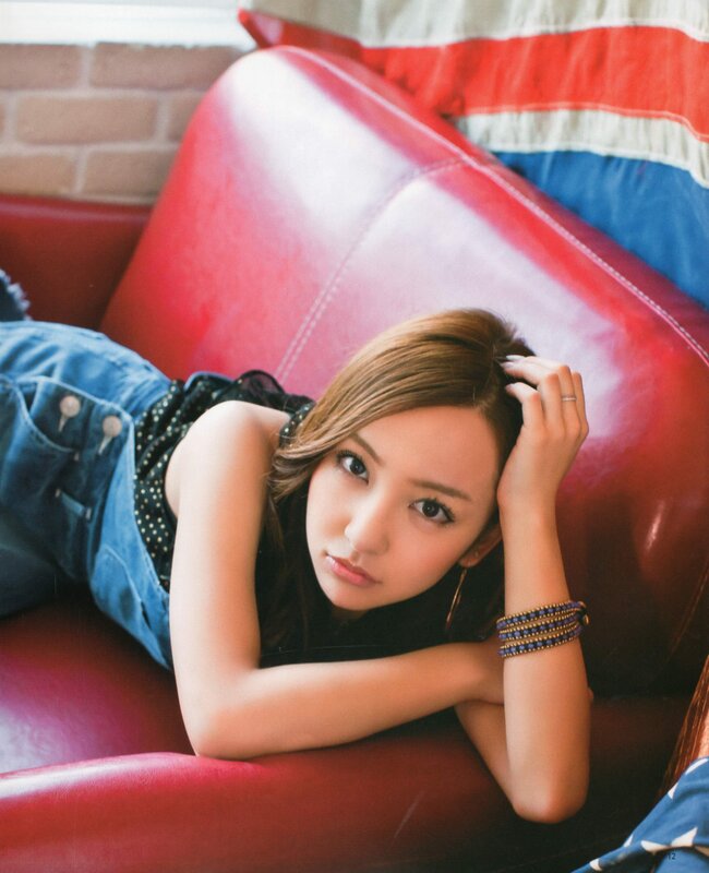 woman lying on red couch