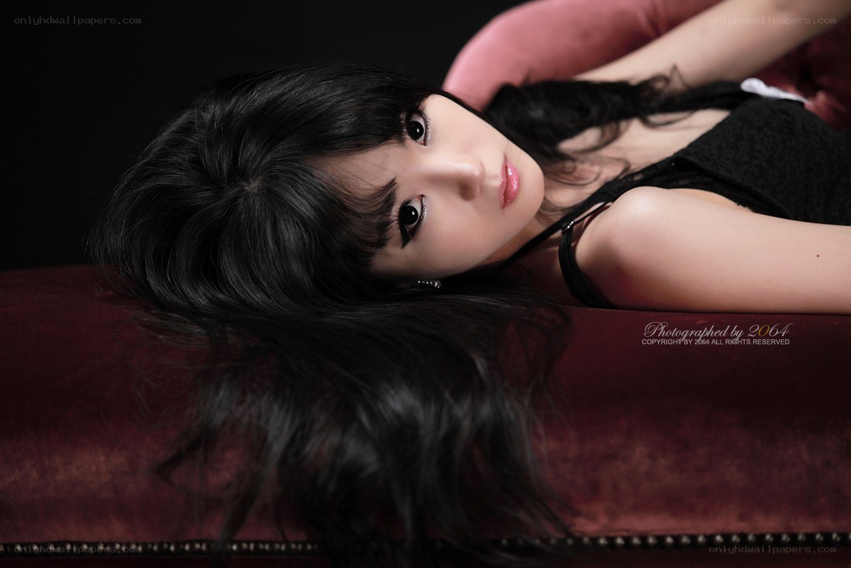 woman lying on red couch