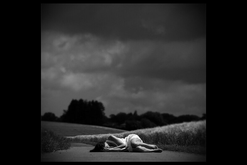 Woman Lying on Road — Black