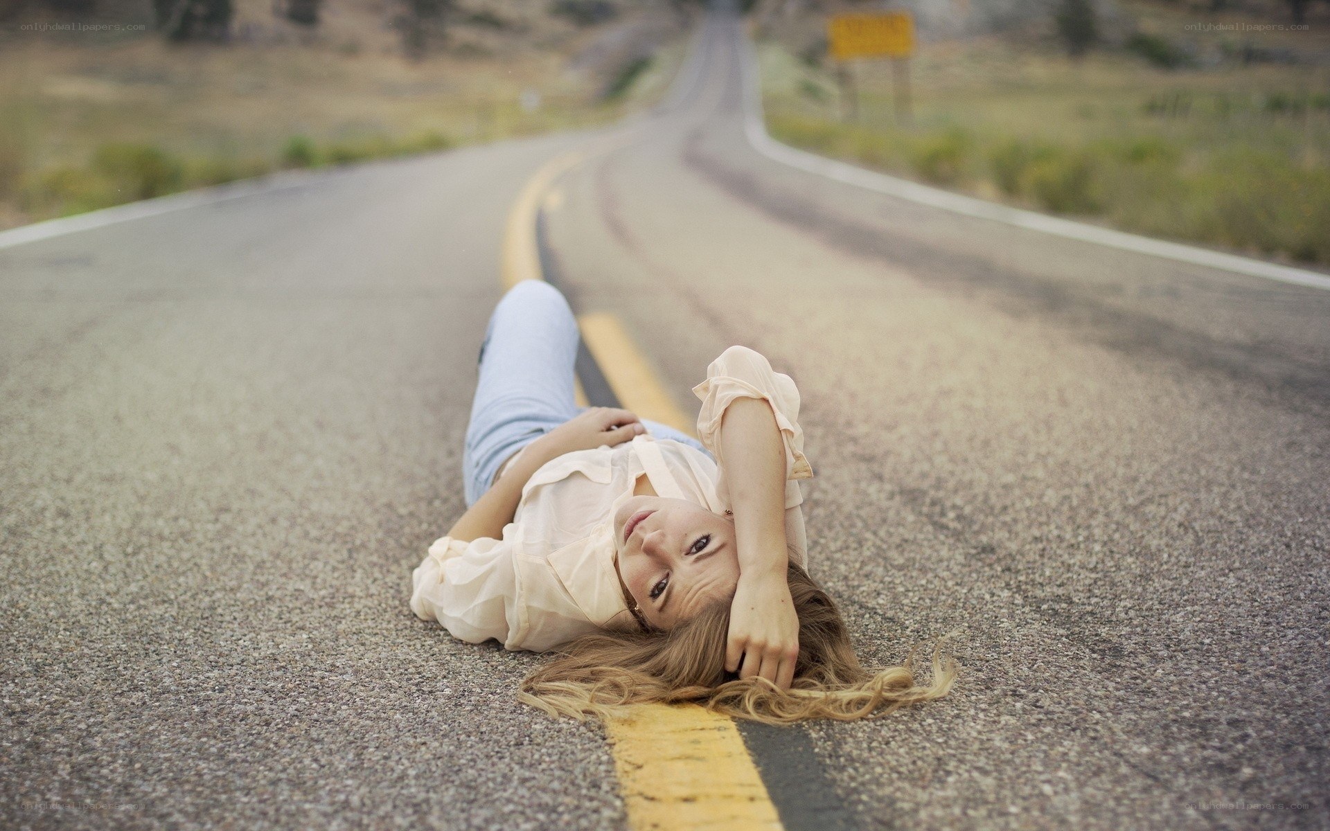 woman lying on road