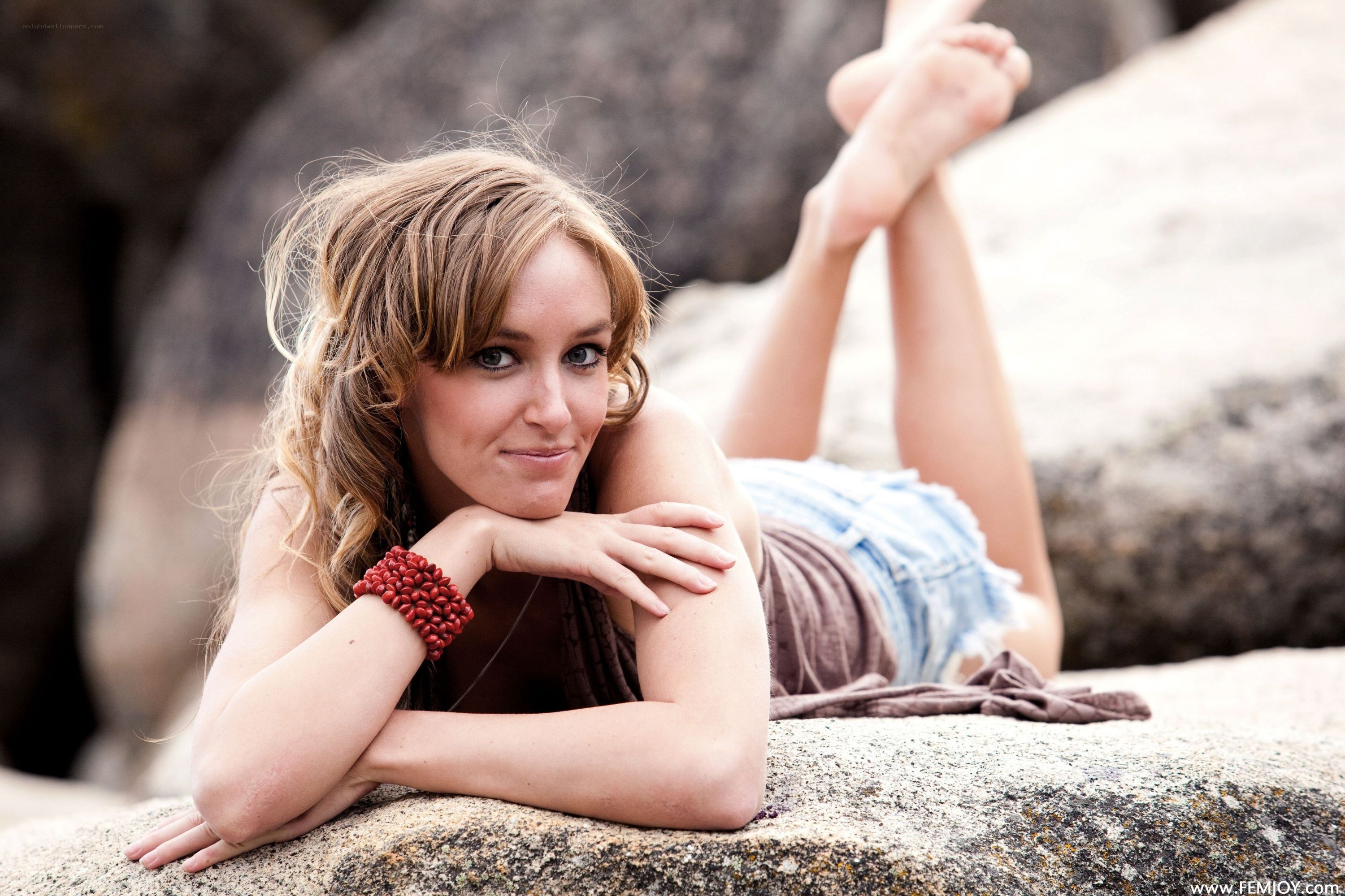 woman lying on rocks
