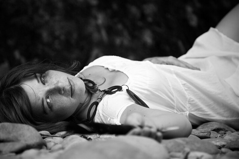 Woman Lying on Rocks — Black, Calm