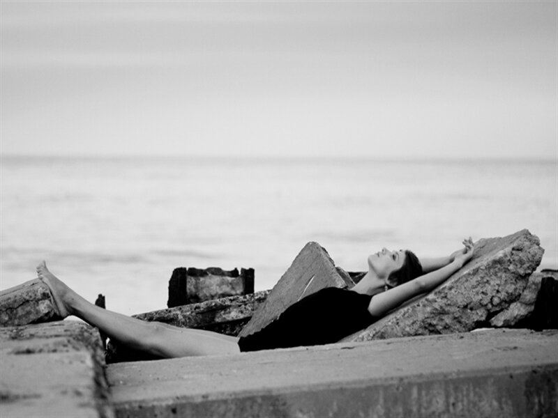 Woman Lying on Rocks — Black, Serene