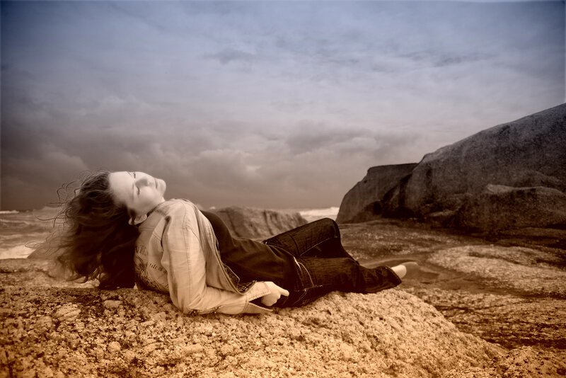 Woman Lying on Rocks — Brown