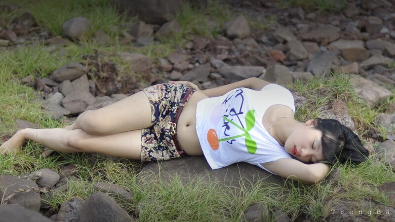Woman Lying on Rocks — Green, Serene