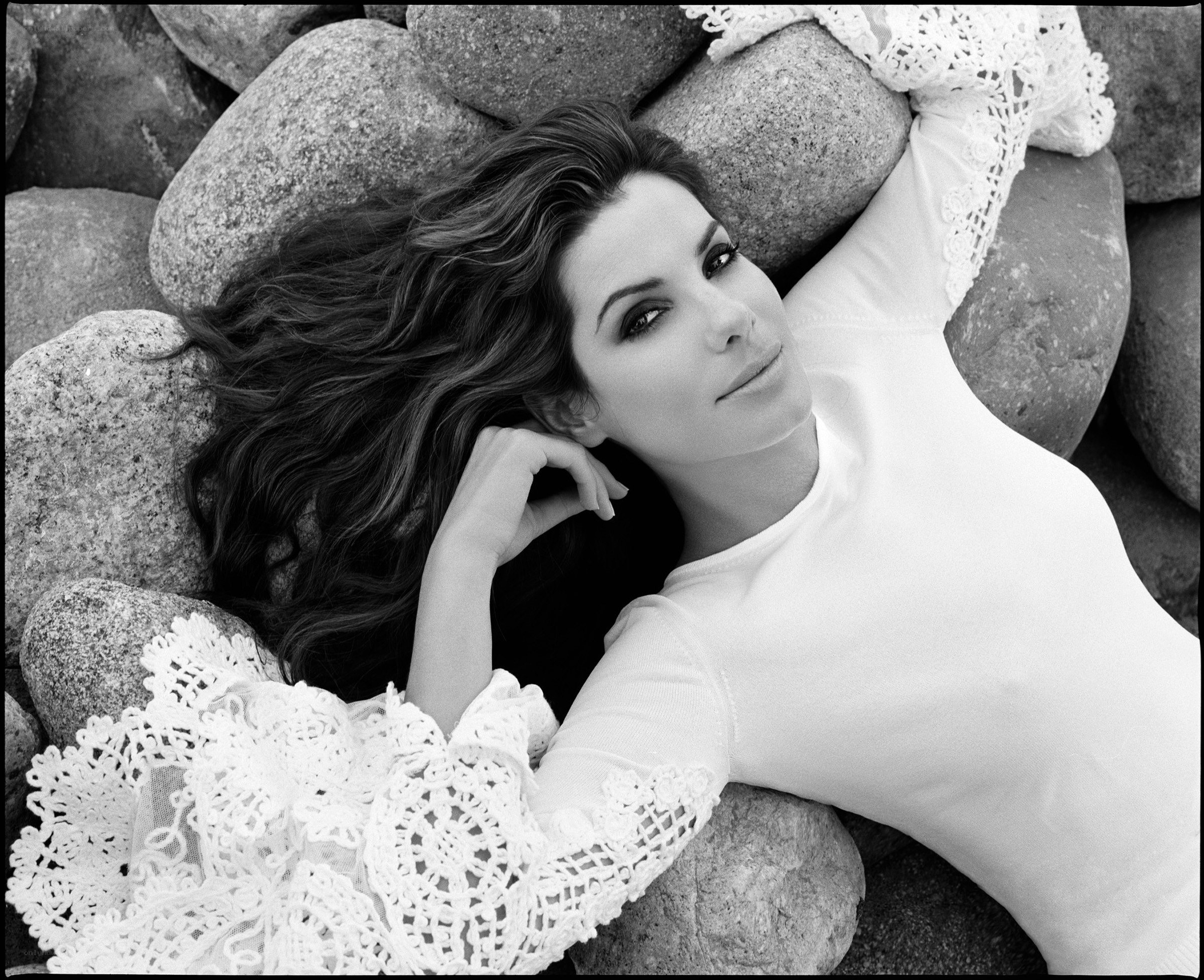 woman lying on rocks