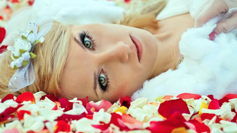 woman lying on rose petals