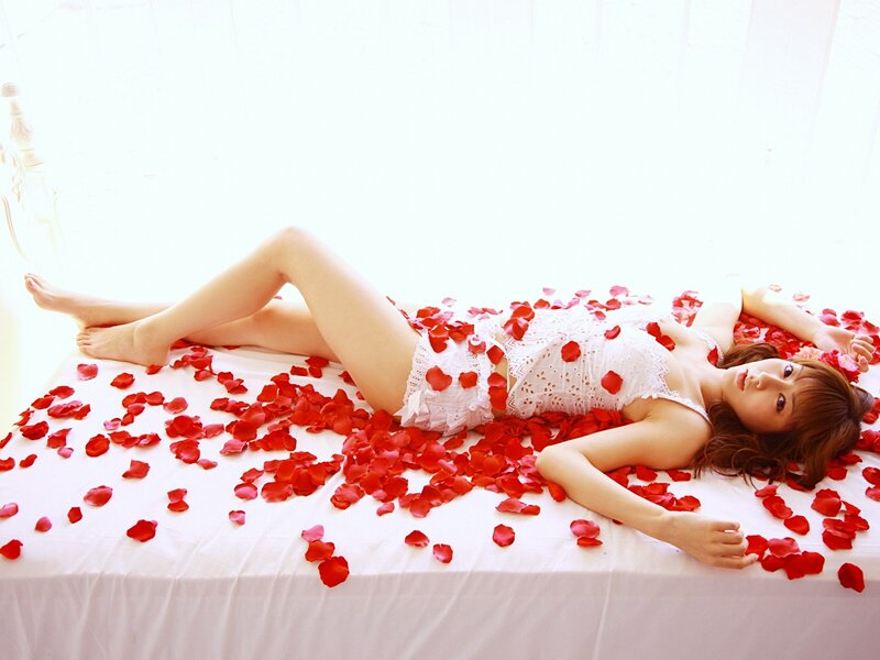 woman lying on rose petals