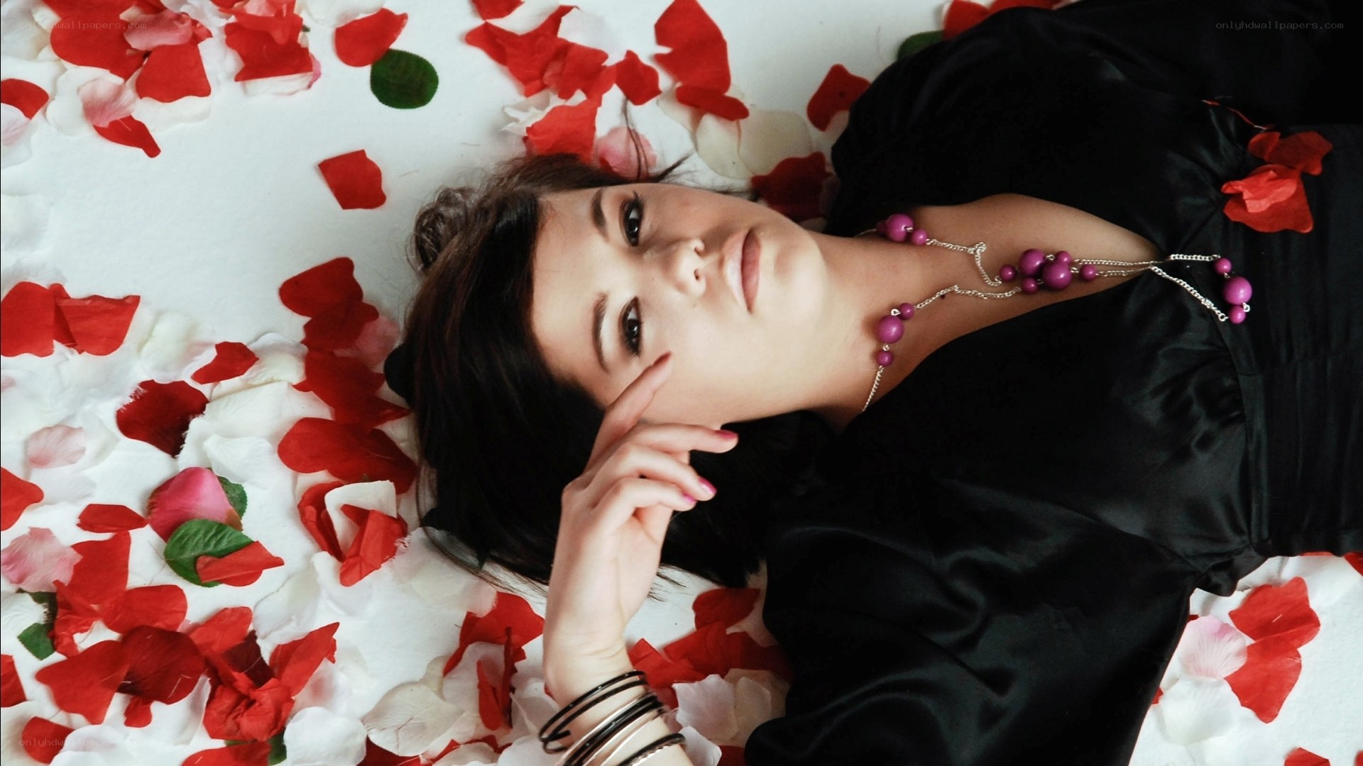woman lying on rose petals
