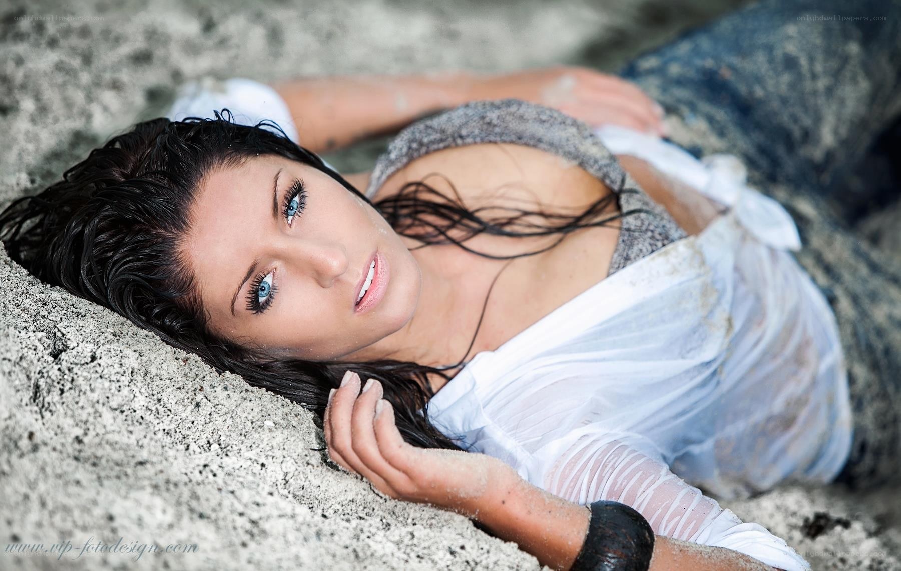 woman lying on sandy beach