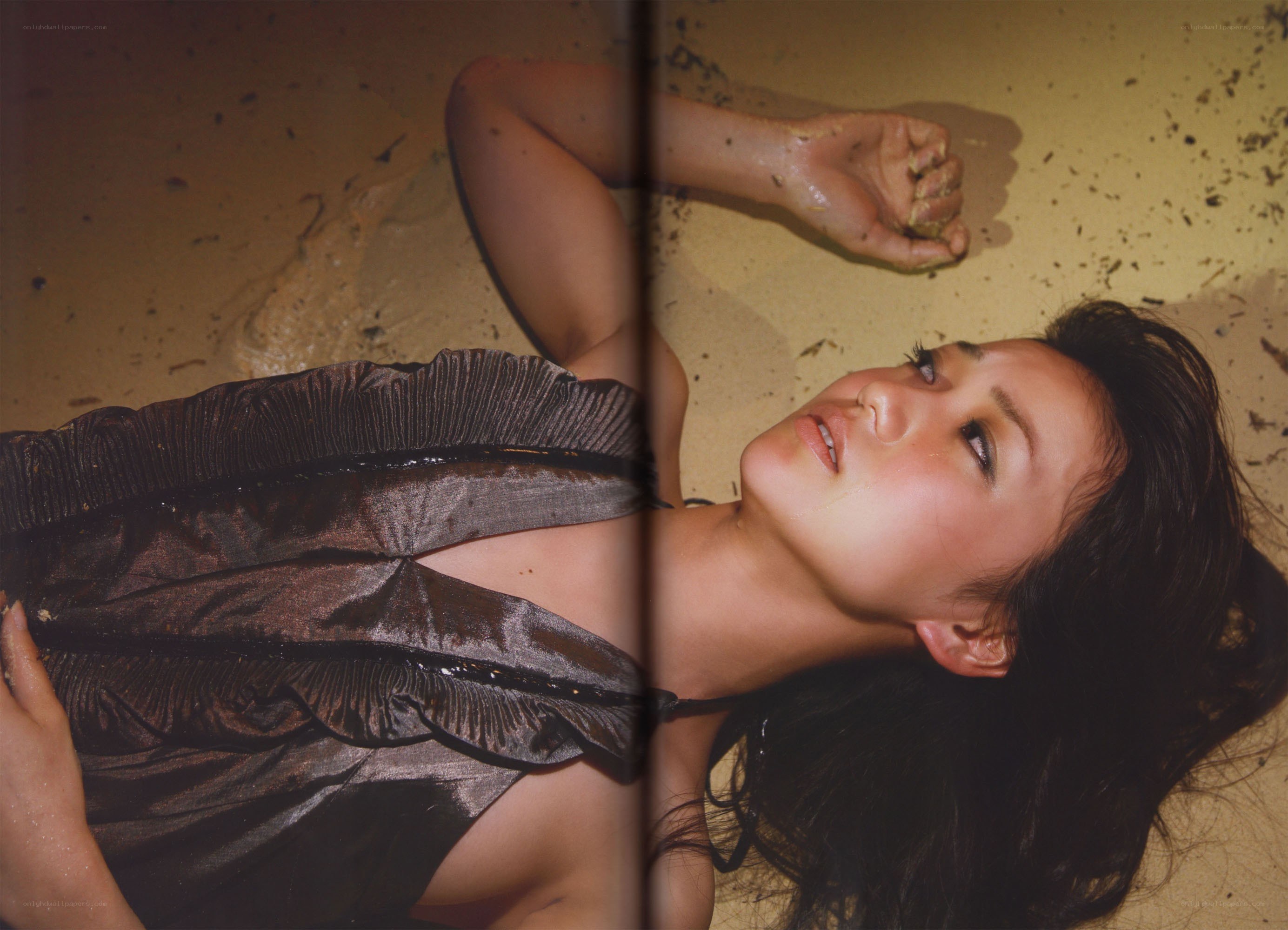 woman lying on sandy ground