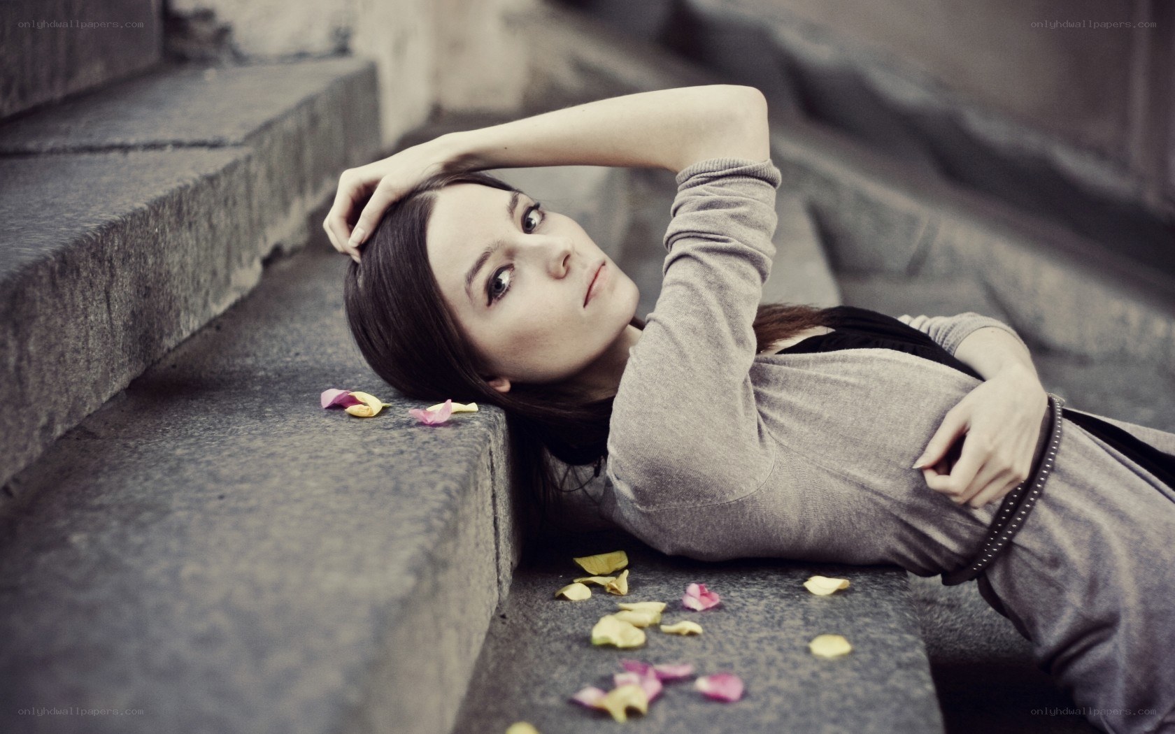 woman lying on stone steps