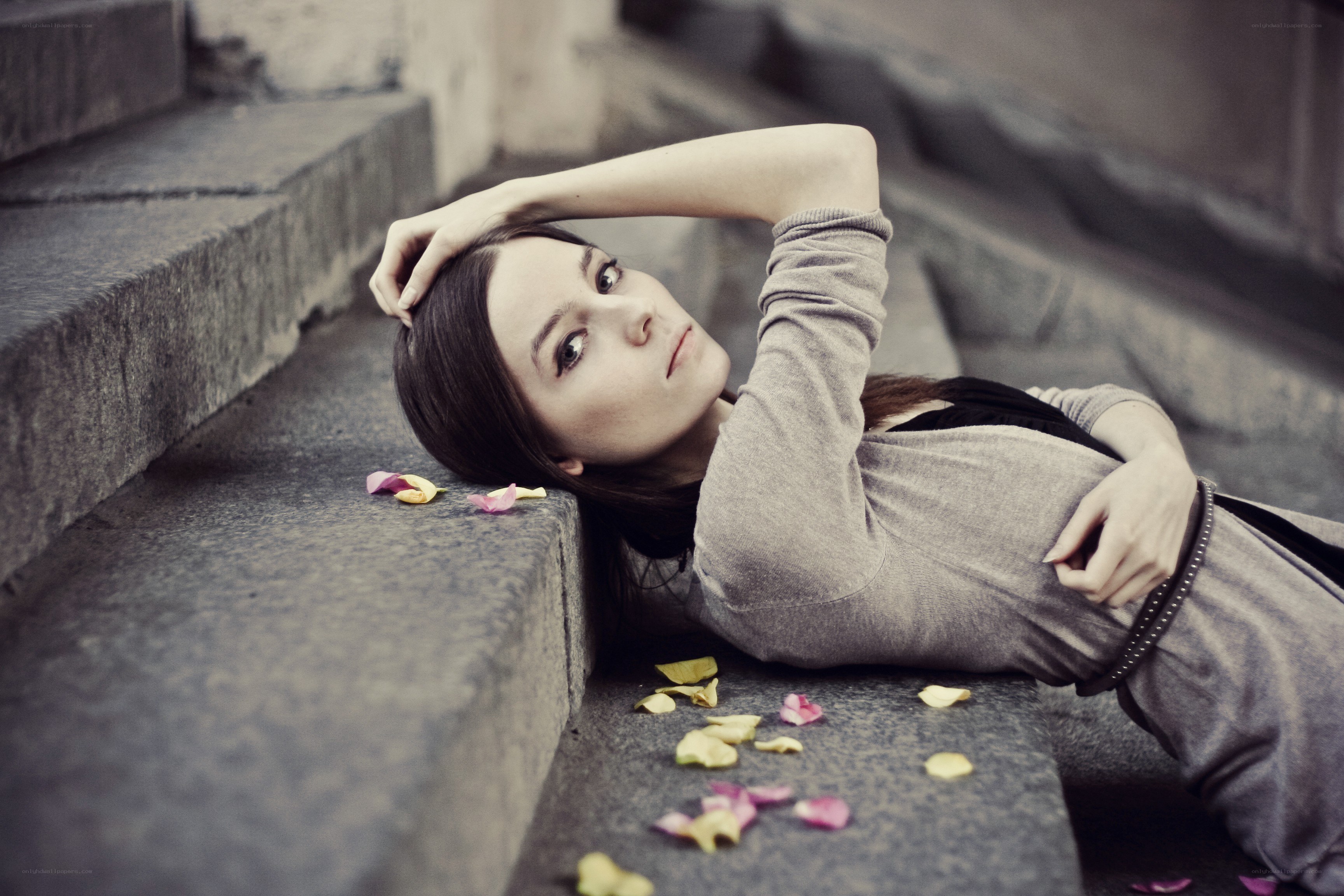 woman lying on stone steps