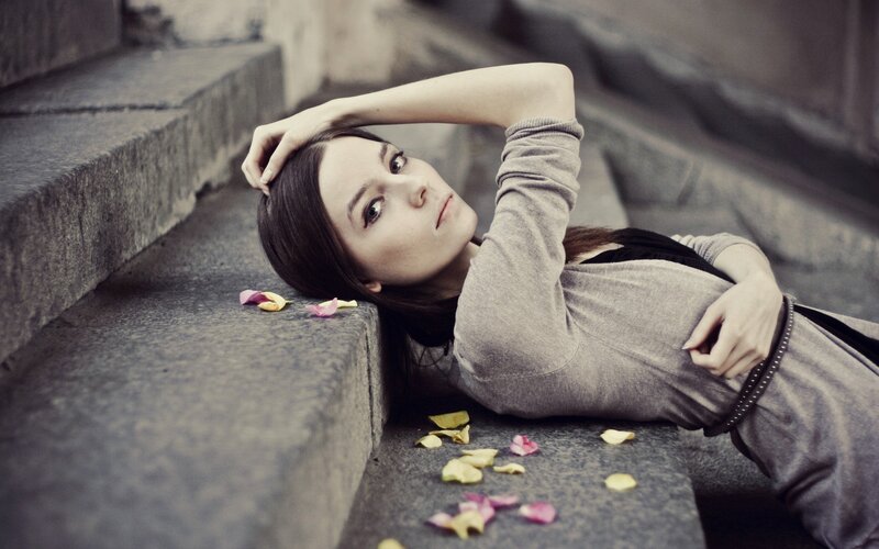 woman lying on stone steps