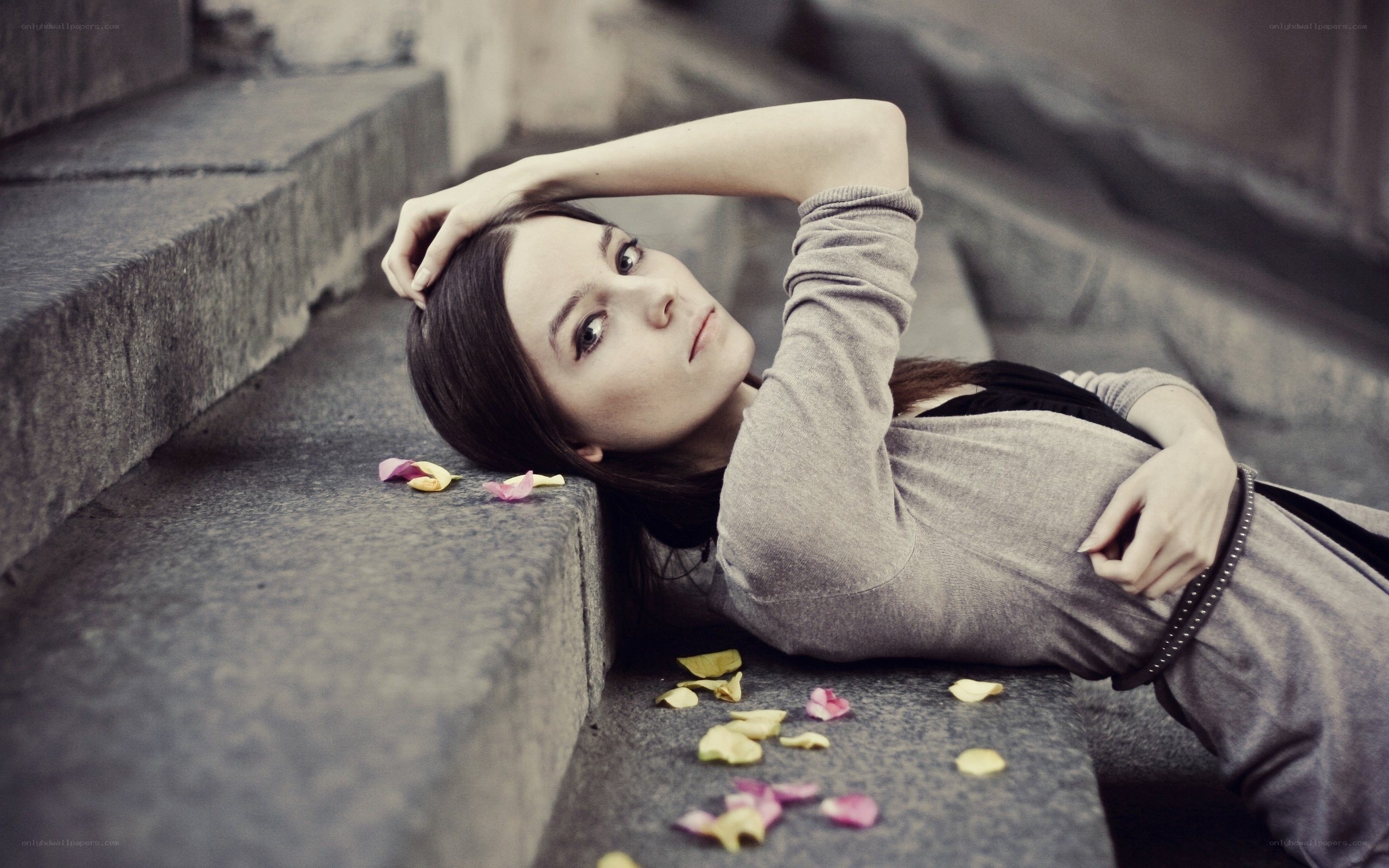 woman lying on stone steps