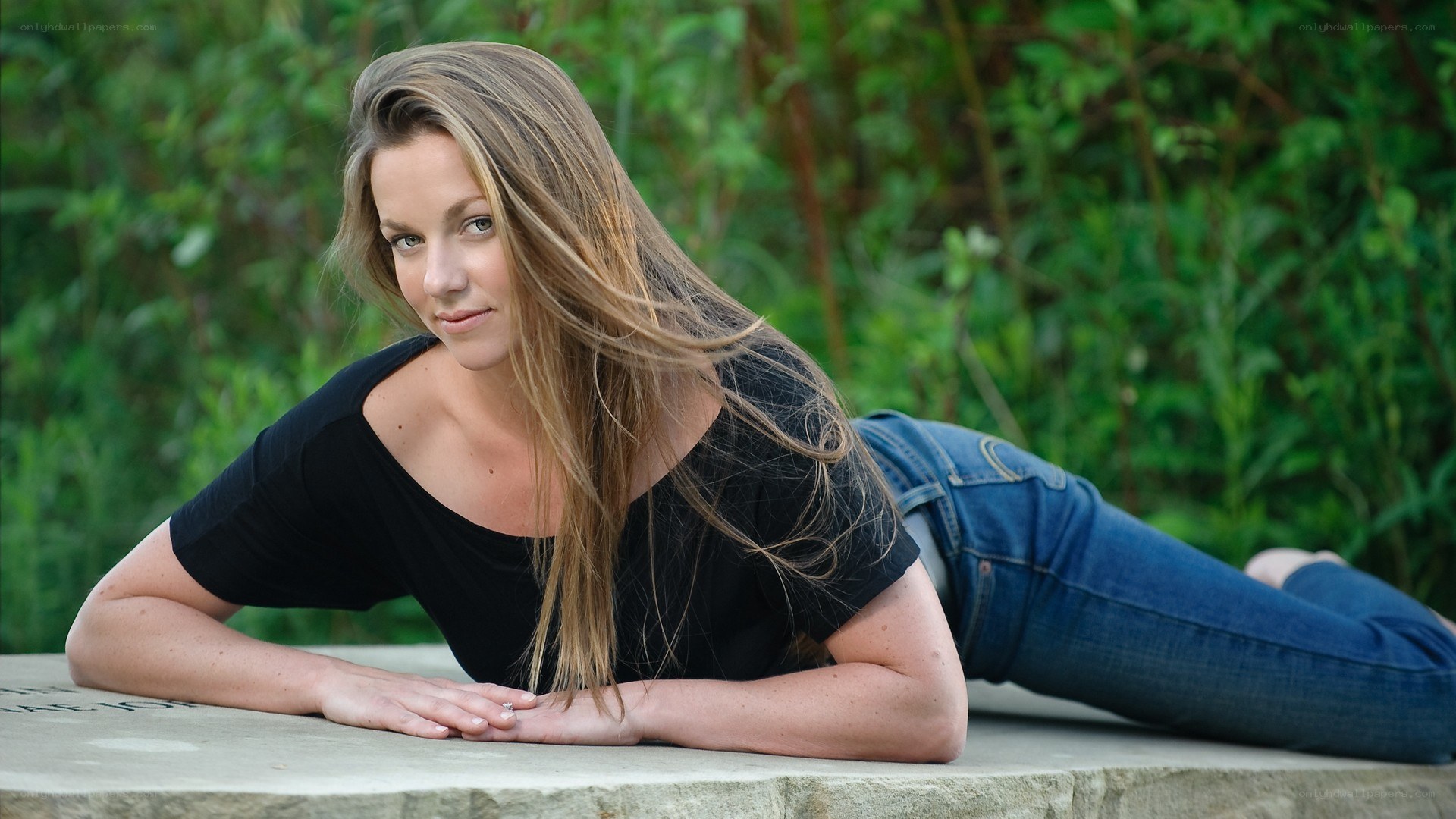 woman lying on stone surface