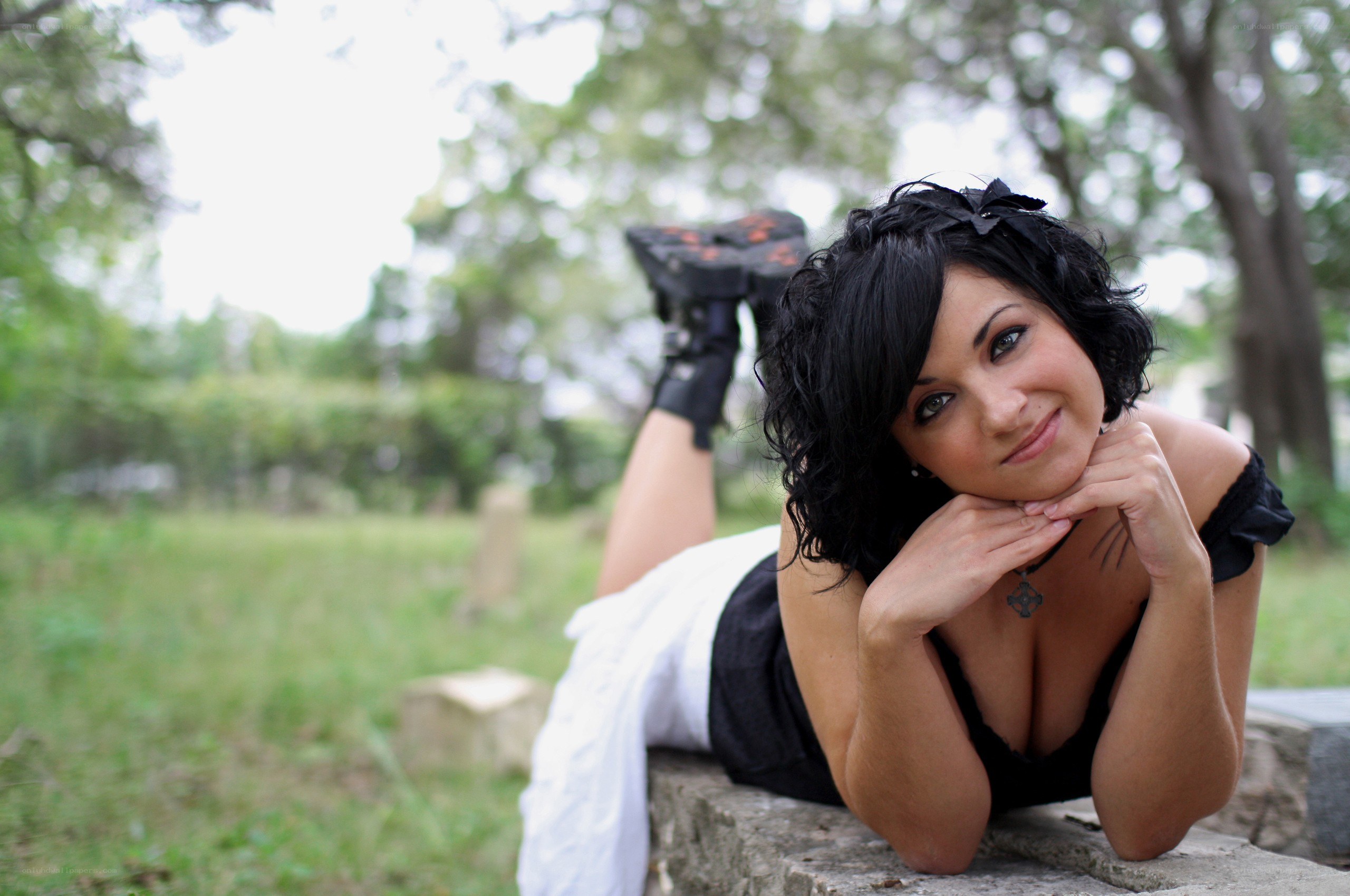 woman lying on stone wall