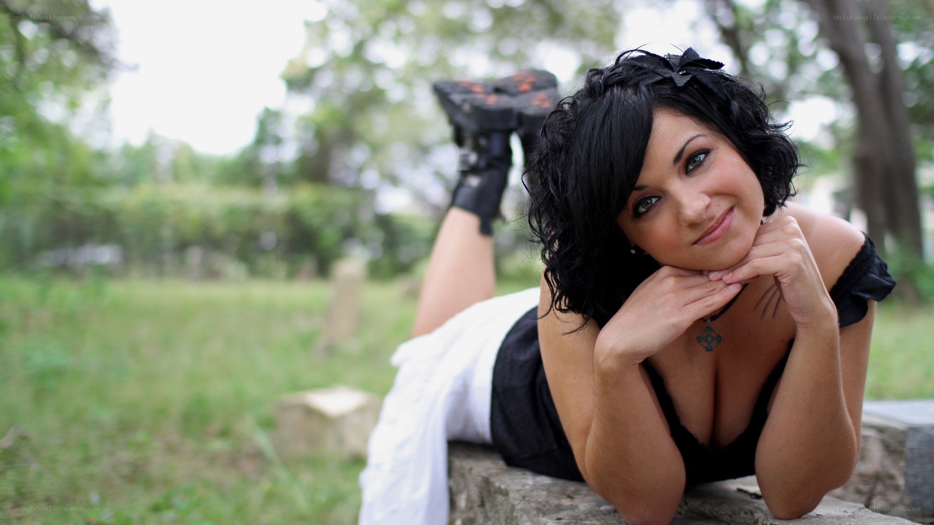 woman lying on stone wall